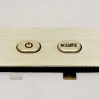 Square metal membrane switch from Marking Systems with a power button and an “Acquire” button.