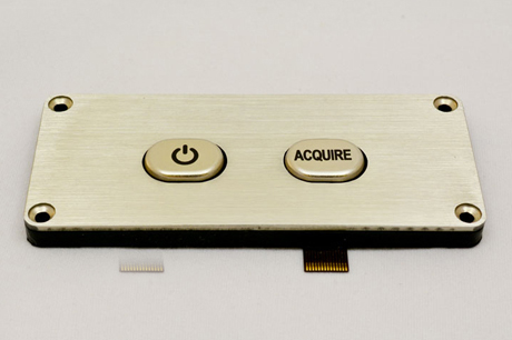 Square metal membrane switch from Marking Systems with a power button and an “Acquire” button.