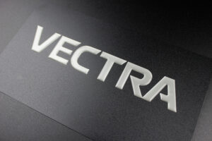 Front view of the Vectra scripting dome nameplate from Marking Systems.