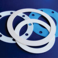 Four gaskets from Marking Systems for die-cut label printing staggard stacked on one another.