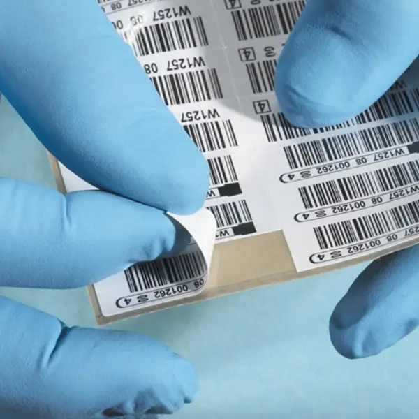 Peeling off barcode with medical gloves